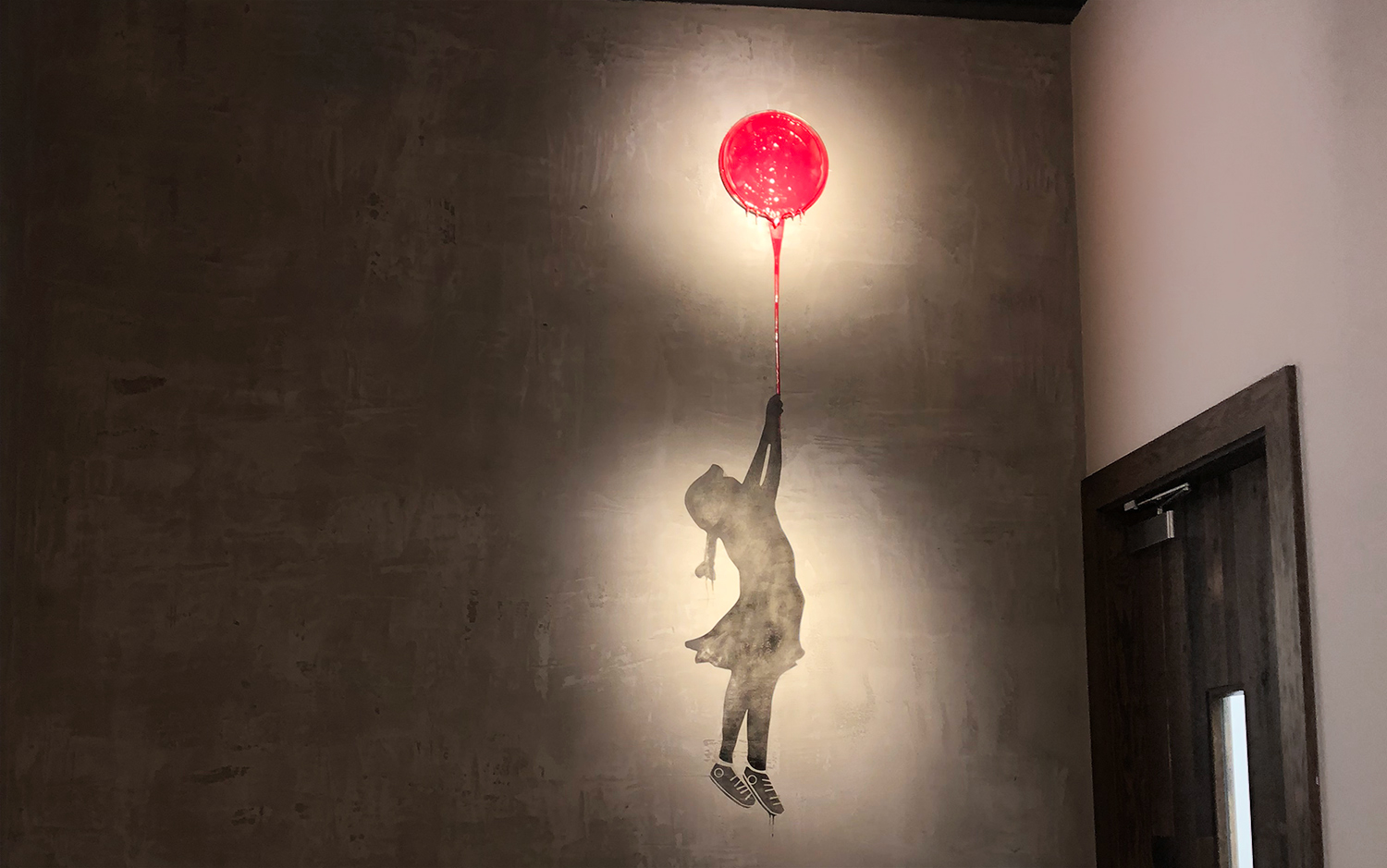 painting of a girl holding a paint lid as a balloon