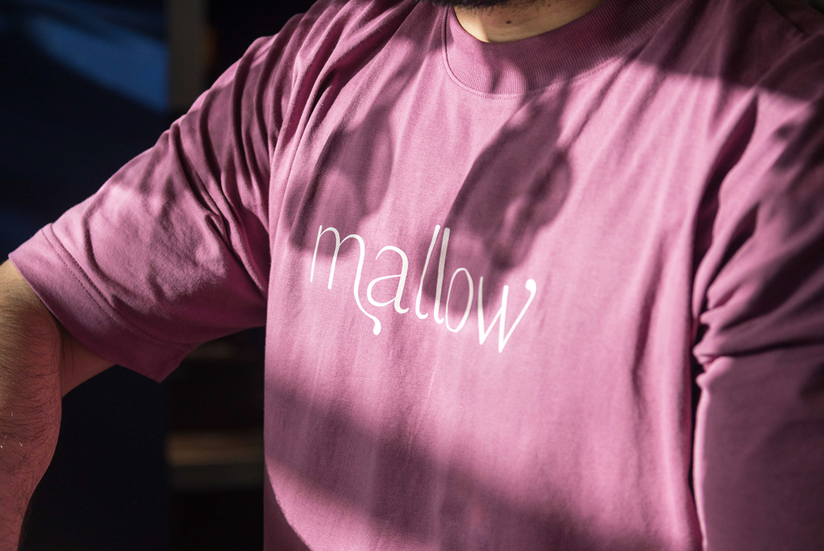 Uniform t-shirt in dark pink with the brand wordmark in a lighter pink. By SAINT Design for mallow, a vegan restaurant in London.